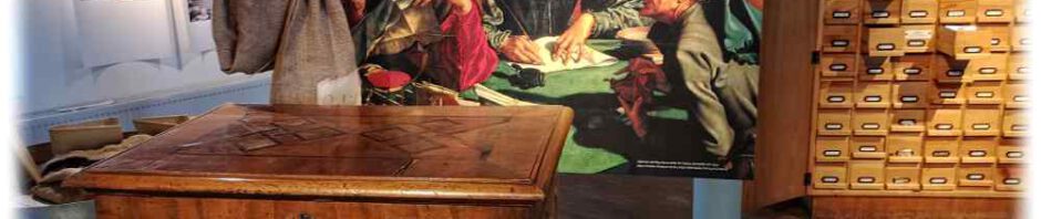 "Ein Notar" von Marinus van Reymerswalde (1542), davor die Innungslade der Dresdner Kupferschmied-Innung, die nur mit den Schlüsseln dreier Meister geöffnet werden konnte. Darin wurden beispielsweise Lehrbriefe und andere Dokumente verwahrt. Foto: Heiko Weckbrodt